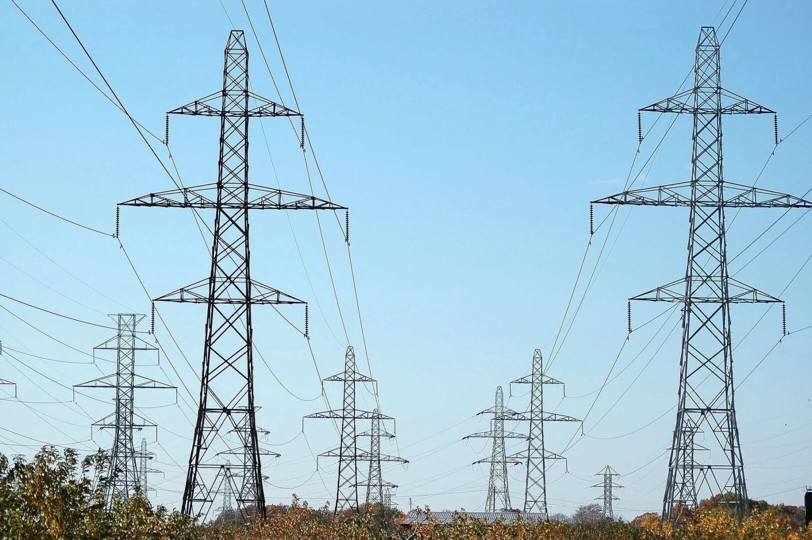 A group of power lines that are in the grass.