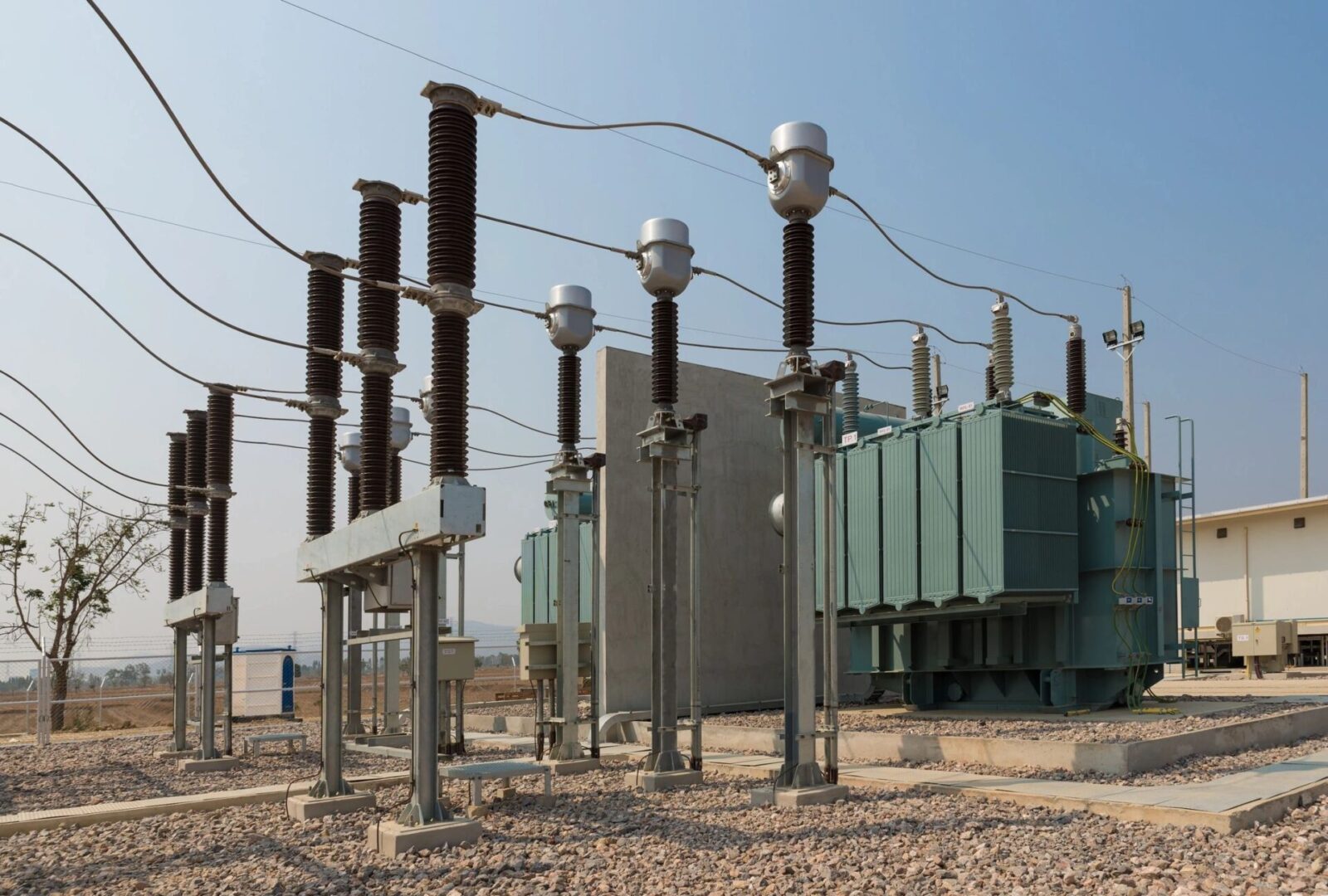 A power plant with many electrical equipment on the ground.